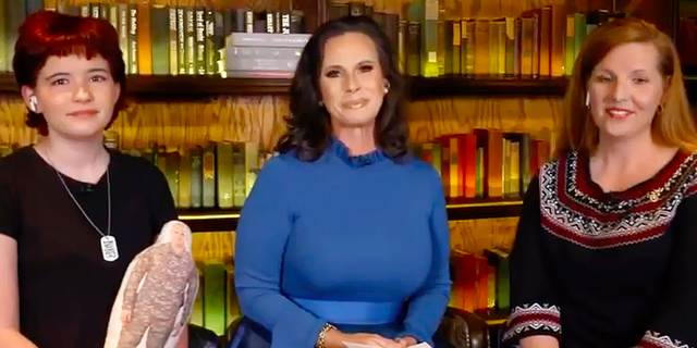 Emma Dozier (left), and her mom, Amy Dozier (far right), appeared with Lyette Reback of the Believe With Me foundation on 'Fox and Friends' on Wed., Dec. 22, 2021. Young Emma is holding what she calls her ‘Daddy Doll.'