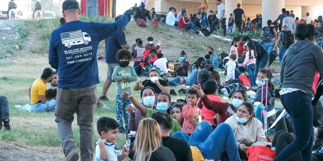 Migrants are seen at the Rio Grande near the Del Rio-Acuna Port of Entry in Del Rio, Texas, on Sept. 18, 2021.