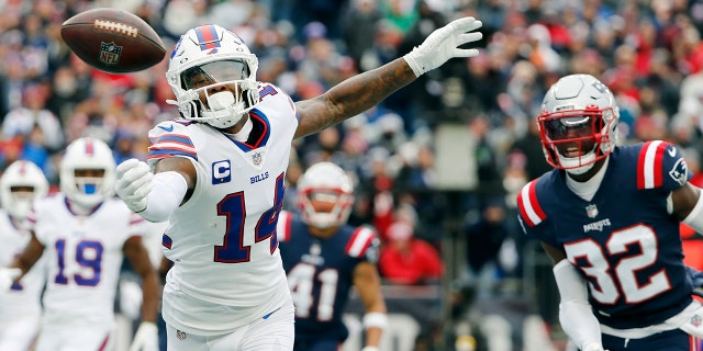 Buffalo Bills wide receiver Stefon Diggs (14) misses a pass against New England Patriots free safety Devin McCourty (32) during the first half Sunday, Dec. 26, 2021, in Foxborough, Mass.