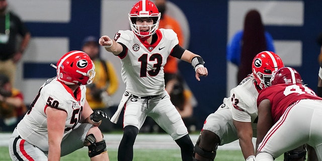 Georgia quarterback Stetson Bennett (13) calls audible against Alabama during the first half of the Southeastern Conference championship NCAA college football game, Saturday, Dec. 4, 2021, in Atlanta.