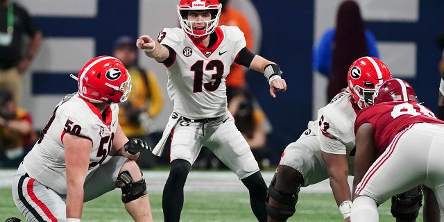 Georgia quarterback Stetson Bennett (13) calls audible against Alabama during the first half of the Southeastern Conference championship NCAA college football game, Saturday, Dec. 4, 2021, in Atlanta.