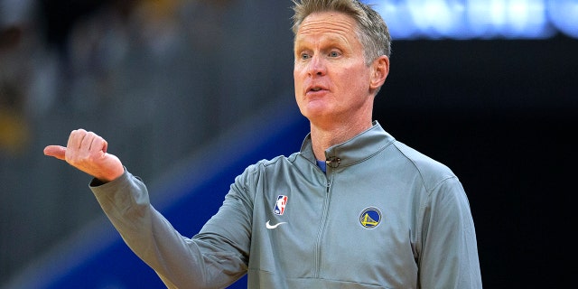 Golden State Warriors coach Steve Kerr signals to players during the first quarter of the team's NBA basketball game against the Philadelphia 76ers, Wednesday, Nov. 24, 2021, in San Francisco.