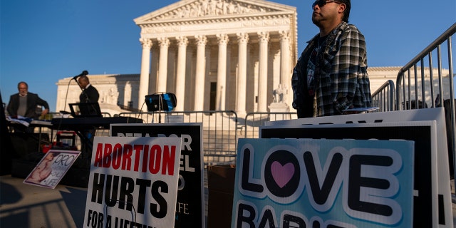 People gather at an anti-abortion rally outside the Supreme Court in Washington, Tuesday, Nov. 30, 2021. (AP Photo/Andrew Harnik)