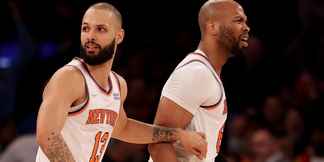 Taj Gibson (67) of the New York Knicks is held back by teammate Evan Fournier (13) after Gibson is called for double technical fouls and is ejected from the game in the first half against the Chicago Bulls at Madison Square Garden Dec. 2, 2021 a New York City.