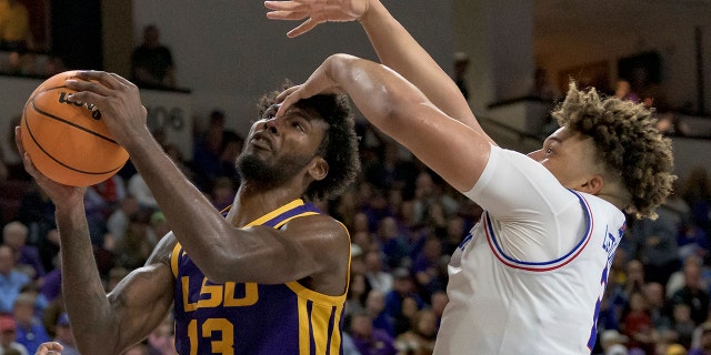 LSU forward Tari Eason (13) is fouled near his eye by Louisiana Tech forward Kenneth Lofton Jr. (2) during the second half of an NCAA college basketball game in Bossier City, La., Saturday, Dec. 18, 2021.