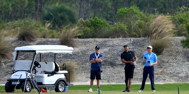 Tiger Woods of the United States hits balls on the range during the third round of the Hero World Challenge at Albany Golf Course in Nassau Dec. 4, 2021.