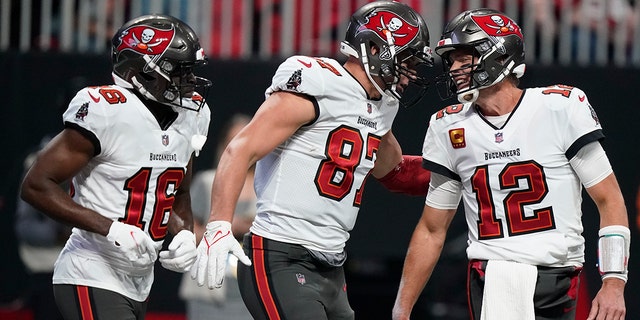 Tampa Bay Buccaneers tight end Rob Gronkowski (87) celebrates his touchdown with Tampa Bay Buccaneers quarterback Tom Brady (12) during the first half of an NFL football game against the Atlanta Falcons, Sunday, Dec. 5, 2021, in Atlanta.