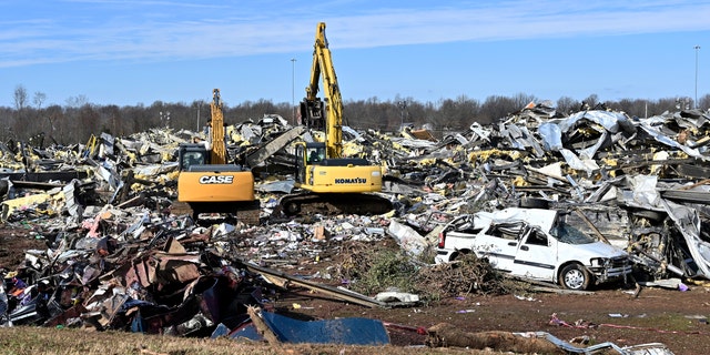 Emergency response workers dig through the rubble of the Mayfield Consumer Products candle factory in Mayfield, Ky., Saturday, Dec. 11. Tornadoes and severe weather caused catastrophic damage across multiple states late Friday, killing several people overnight. 