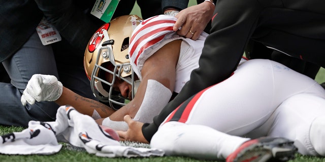 San Francisco 49ers running back Trenton Cannon is tended to after an injury during the first half of an NFL football game against the Seattle Seahawks, Sunday, Dec. 5, 2021, in Seattle.