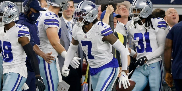 Dallas Cowboys' Trevon Diggs (7) celebrates intercepting a pass thrown by Washington Football Team's Taylor Heinicke in the first half of an NFL football game in Arlington, Texas, Sunday, Dec. 26, 2021.