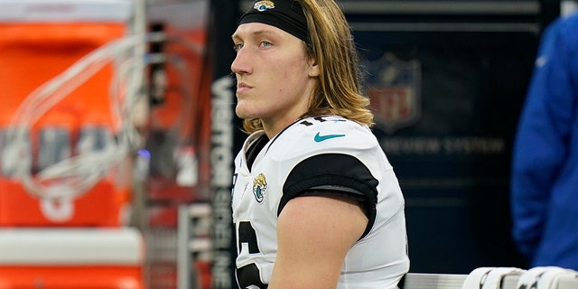 Jacksonville Jaguars quarterback Trevor Lawrence sits on the sideline in the final minutes of a loss to the Los Angeles Rams during the second half of an NFL football game Sunday, Dec. 5, 2021, in Inglewood. , Calif.