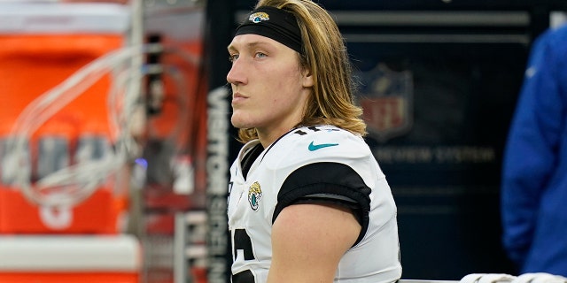 Jacksonville Jaguars quarterback Trevor Lawrence sits on the bench in the closing minutes of a loss to the Los Angeles Rams during the second half of an NFL football game Sunday, Dec. 5, 2021, in Inglewood, Calif.