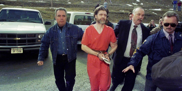Theodore "Ted" Kaczynski is guided to his arraignment in Helena, Montana, on April 4, 1996, following his arrest in connection with the "Unabomber" investigation.