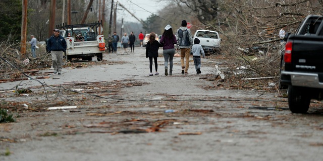 Bowling Green, Kentucky, residents look at the damage following a tornado that struck the area