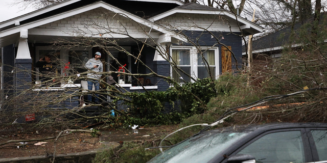 Bowling Green, Kentucky, residents look at the damage following a tornado that struck the area on December 11, 2021. (Photo by Gunnar Word / AFP) (Photo by GUNNAR WORD/AFP via Getty Images)