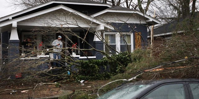 Bowling Green, Kentucky, residents look at the damage following a tornado that struck the area on December 11, 2021. (Photo by Gunnar Word / AFP) (Photo by GUNNAR WORD/AFP via Getty Images)