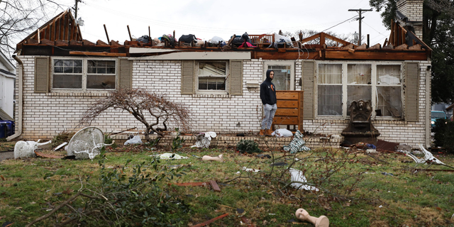 A Bowling Green, 肯塔基州, resident surveys the damage following a tornado that struck the area on December 11, 2021.