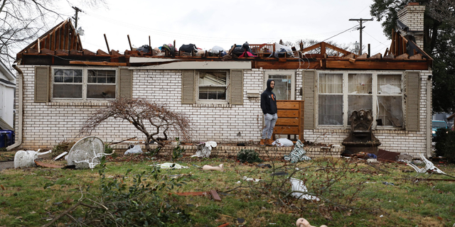 A Bowling Green, Kentucky, resident surveys the damage following a tornado that struck the area on December 11, 2021.