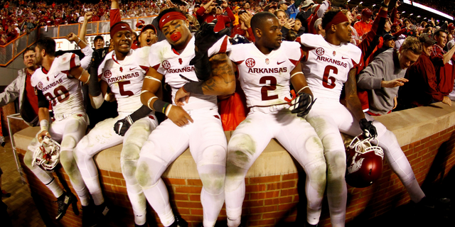 A few members of the Arkansas Razorbacks celebrate with the fans after the victory. 