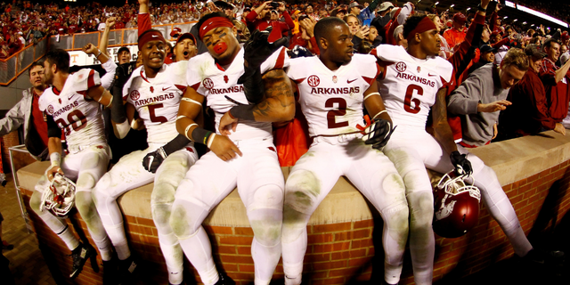 A few members of the Arkansas Razorbacks celebrate with the fans after the victory.