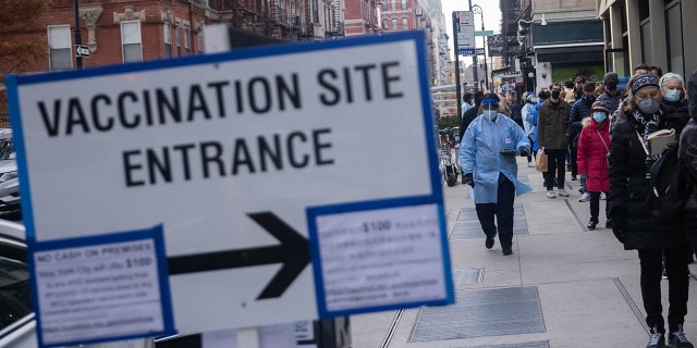 Residents wait in line at a Covid-19 vaccination site in the Chinatown neighborhood of New York. Photographer: Jeenah Moon/Bloomberg via Getty Images