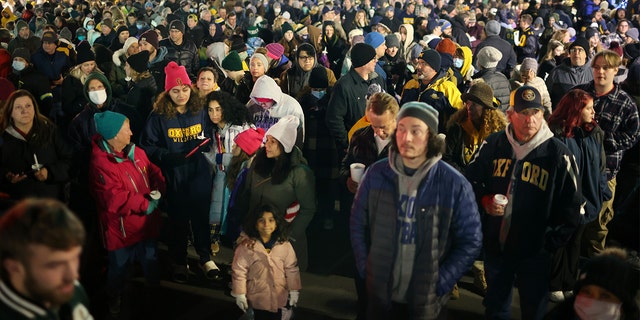 People attend a vigil downtown to honor those killed and wounded during the recent shooting at Oxford High School on December 03, 2021 in Oxford, Michigan. (Photo by Scott Olson/Getty Images)