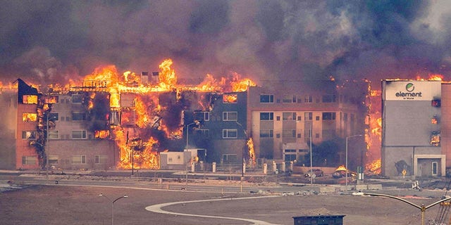 Structures burn, including an Element Hotel, as a wind-driven wildfire forced evacuation of the Superior suburb of Boulder, Colorado, U.S. December 30, 2021.  Trevor Hughes/USA Today Network via Reuters