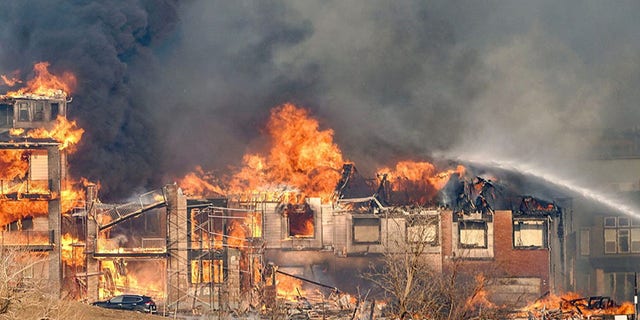 Structures burn as a wind-driven wildfire forced evacuation of the Superior suburb of Boulder, Colorado, on Dec. 30, 2021.  