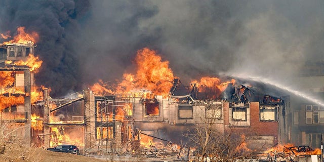 Structures burn as a wind-driven wildfire forced evacuation of the Superior suburb of Boulder, Colorado, on Dec. 30, 2021.