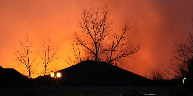 Flames explode as wildfires burned near a shopping center Thursday, dic. 30, 2021, near Broomfield, Colo. Homes surrounding the Flatiron Crossing mall were being evacuated as wildfires raced through the grasslands as high winds raked the intermountain West.