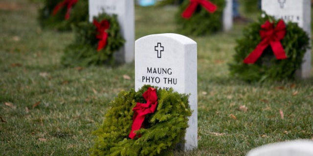 Wreaths lay at the foot of headstones in Section 60 of Arlington National Cemetery.