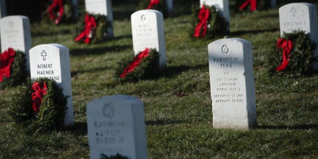 ARLINGTON, VA - DECEMBER 13: Wreaths are seen on graves at Arlington National Cemetery December 13, 2008 in Arlington, Virginia. Worchester Wreath Company of Harrington, Maine and the Maine State Society sponsored the event where about 10,000 holiday wreaths were placed at graves in Section 12 or Arlington National Cemetery.