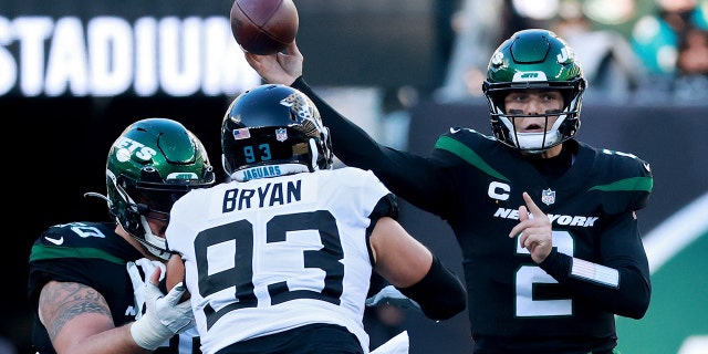 Zach Wilson (2) of the New York Jets throws the ball for a first down during the second quarter in a game against the Jacksonville Jaguars at MetLife Stadium Dec. 26, 2021, in East Rutherford, N.J.