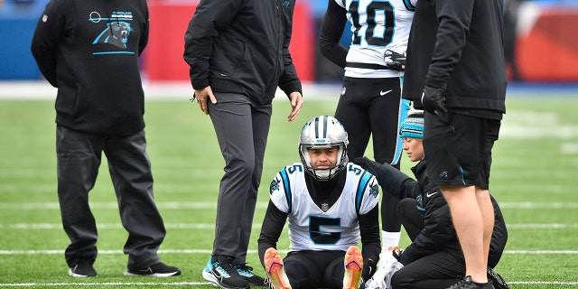 Carolina Panthers kicker Zane Gonzalez is checked after an apparent injury during practice before the Buffalo Bills game, Sunday, Dec. 19, 2021, in Orchard Park, New York.