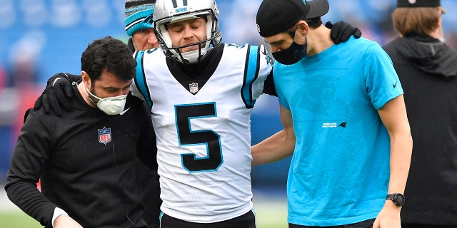 Carolina Panthers kicker Zane Gonzalez is helped off the field after an apparent injury during practice before the Buffalo Bills game, Sunday, Dec. 19, 2021, in Orchard Park, New York.