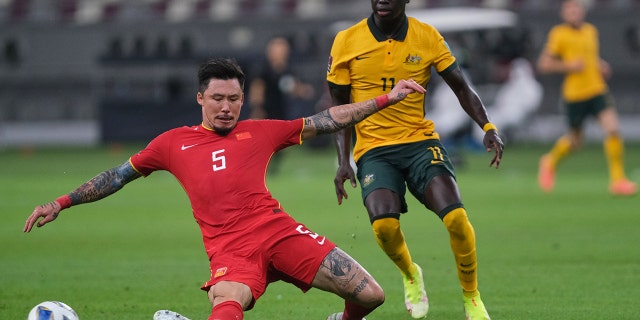 Zhang Linpeng tackles Awer Mabil during Australia v. China PR - 2022 FIFA World Cup Qualifier at Khalifa International Stadium on Sept. 2, 2021, in Doha, Qatar.