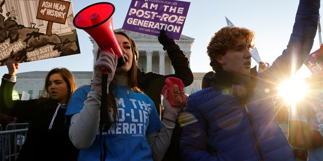 Anti-abortion rights activists protest outside the Supreme Court in Washington, Dec. 1, 2021.