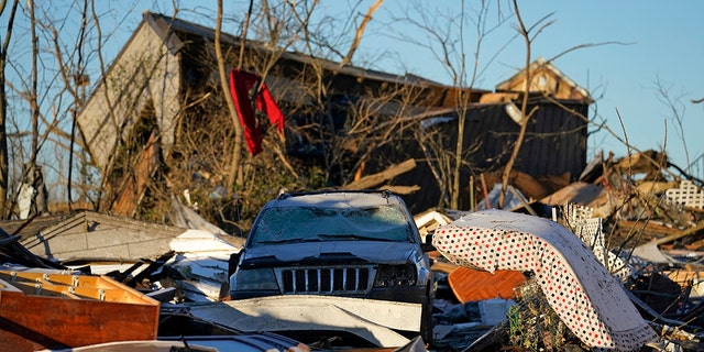 Damaged cars and destroyed homes are seen in the aftermath of tornadoes that tore through the region, in Mayfield, Kentucky, Monday, Dec. 13, 2021. 