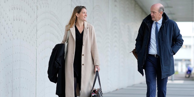 Lawyers for relatives Sabine ten Doesschate, left, and Boudewijn van Eijck arrive outside the court for the ongoing trial and criminal proceedings regarding the downing of Malaysia Airlines flight MH17, at the high-security court at Schiphol airport, near Amsterdam, Netherlands, Monday Dec. 20, 2021.