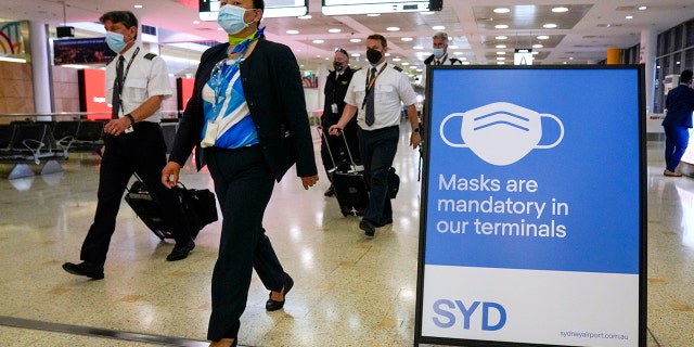 A flight crew walks through the terminal at Sydney Airport on Nov. 29, 2021.