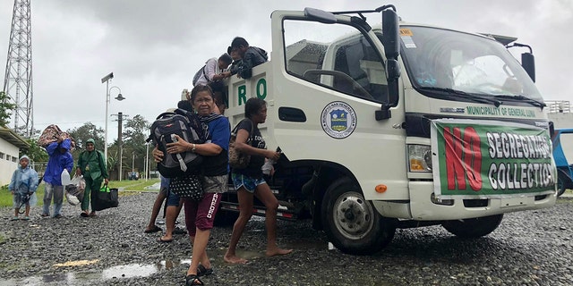 Evacuees arrive at the Siargao Sports Complex in Dapa town, Siargao island, Surigao del Norte province, southern Philippines on Thursday, Dec. 16, 2021. 