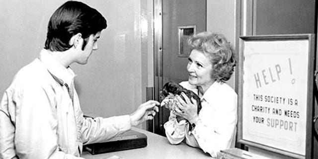 Betty White holding a puppy at an adoption center run by the Society for the Prevention of Cruelty to Animals Los Angeles. 