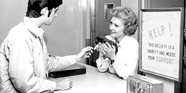 Betty White holding a puppy at an adoption center run by the Society for the Prevention of Cruelty to Animals Los Angeles.
