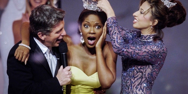 Miss Florida Ericka Dunlap reacts as outgoing Miss America Erika Harold crowns her Miss America 2004 during the competition in Atlantic City, New Jersey, on Sept. 20, 2003.