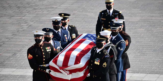 The casket of late Senator Bob Dole arrives to the U.S. Capitol in Washington, D.C., U.S., on Thursday, Dec. 9, 2021. Dole, the World War II veteran who recovered from near-fatal wounds to become the U.S. Senate Republican leader and a three-time presidential candidate, died at 98 on December 5. Photographer: Mandel Ngan/AFP/Bloomberg via Getty Images