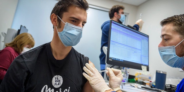 West Hartford, Connecticut, resident Benoit Faugas receives a COVID-19 booster shot at Hartford Hospital as hospitalizations reached 500 for first time since April and health leaders have pushed for more vaccinations and booster shots.