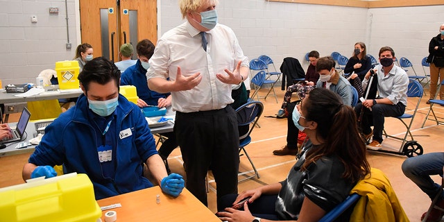 British Prime Minister Boris Johnson visits Stow Health Vaccination center, in Westminster, London, Monday, Dec. 13, 2021.  