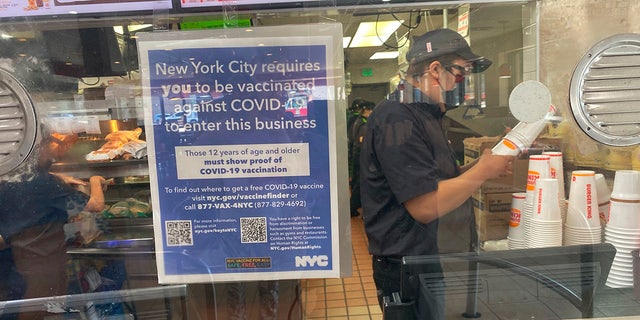 FILE: Vaccine Mandate sign at Burger King Fast food restaurant, Queens, New York. (Photo by: Lindsey Nicholson/Universal Images Group via Getty Images)