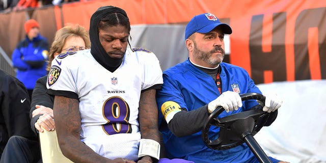 Baltimore Ravens quarterback Lamar Jackson (8) is carted off the field after an injury during the first half of an NFL football game against the Cleveland Browns, Sunday, Dec. 12, 2021, in Cleveland.
