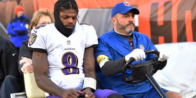 Baltimore Ravens quarterback Lamar Jackson (8) is carted off the field after an injury during the first half of an NFL football game against the Cleveland Browns, Sunday, Dec. 12, 2021, in Cleveland.